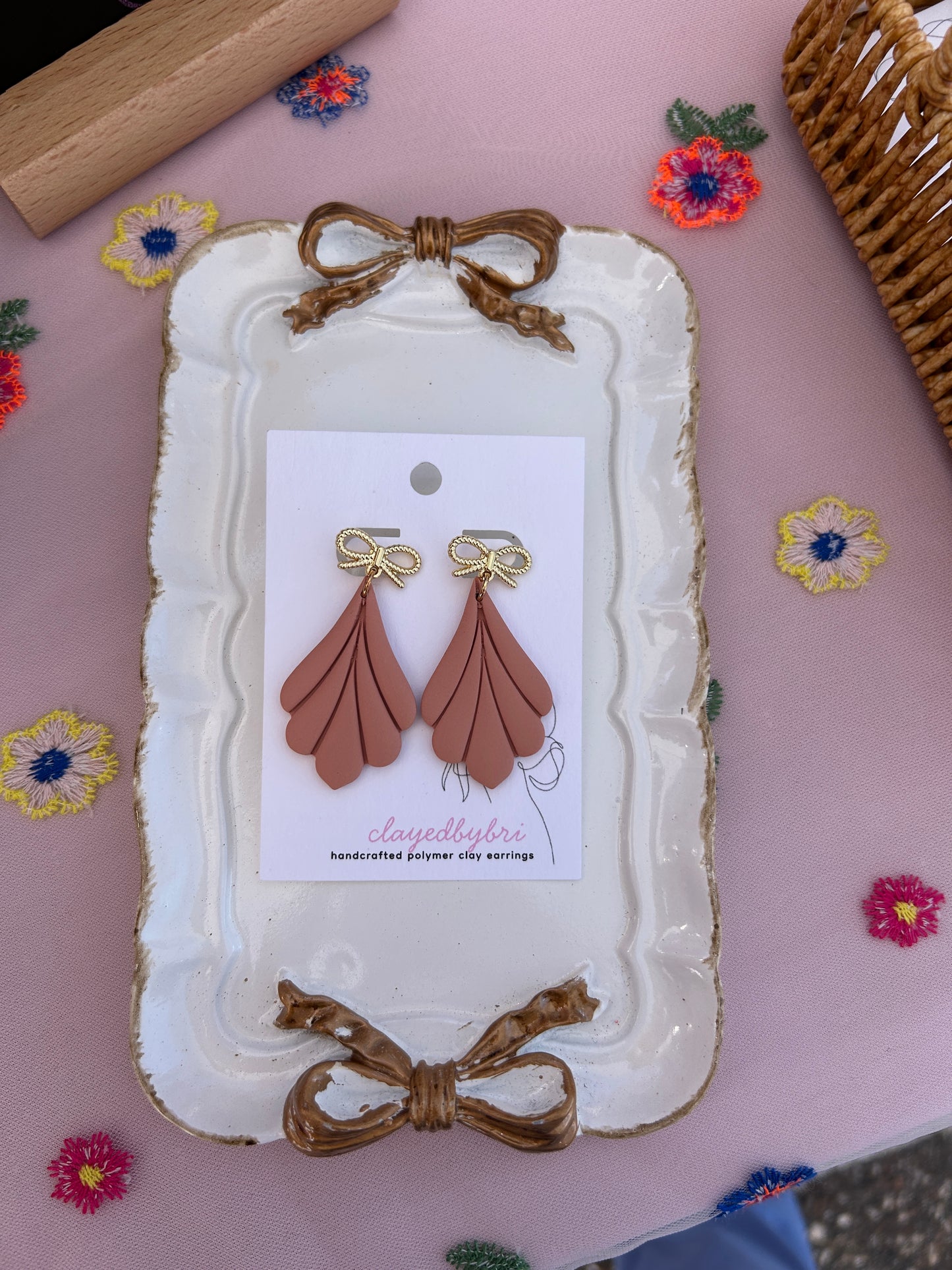 Peach Colored Dangle Earrings with a Gold Bow