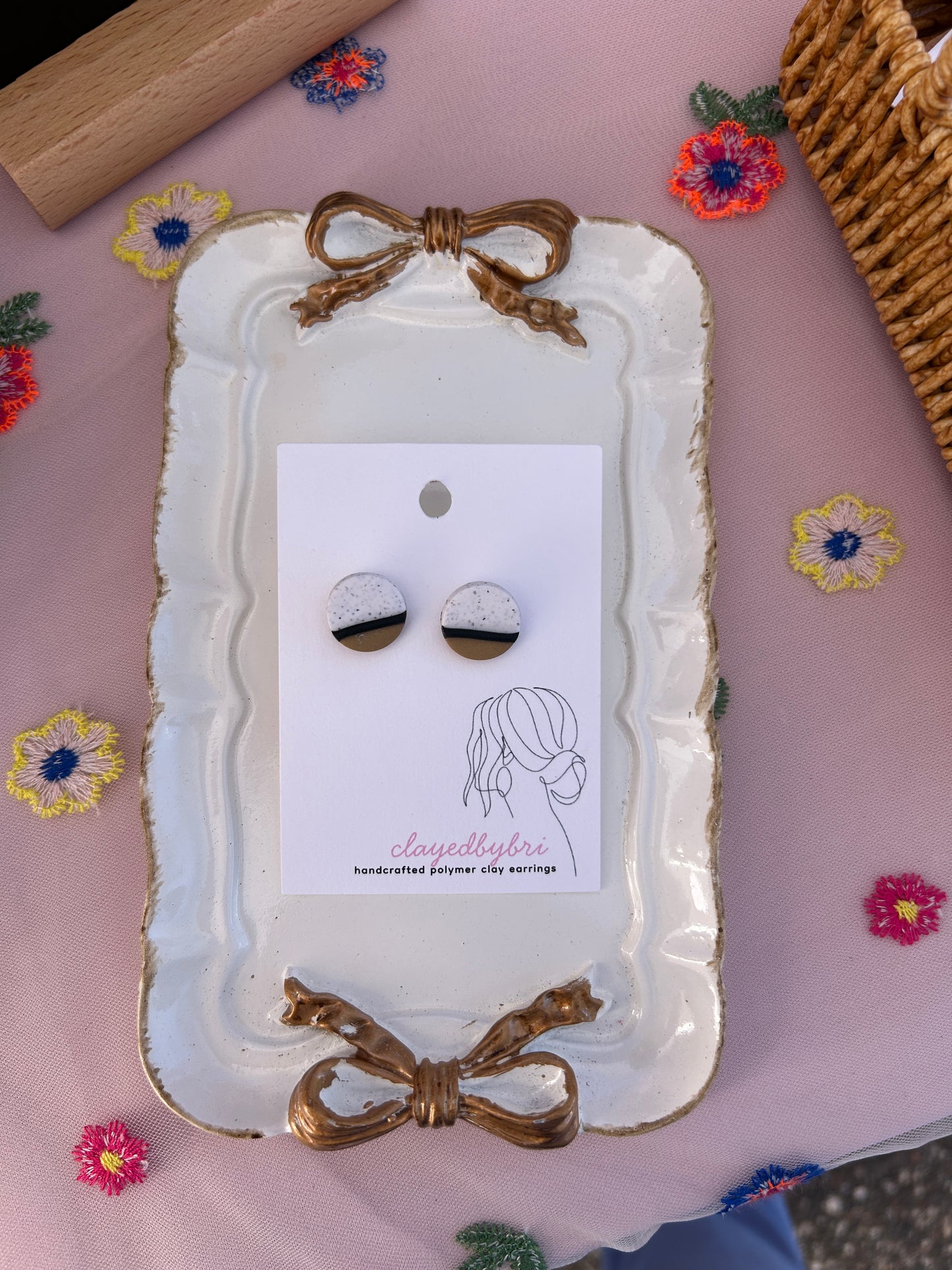 White, Black, and Tan Round Studs